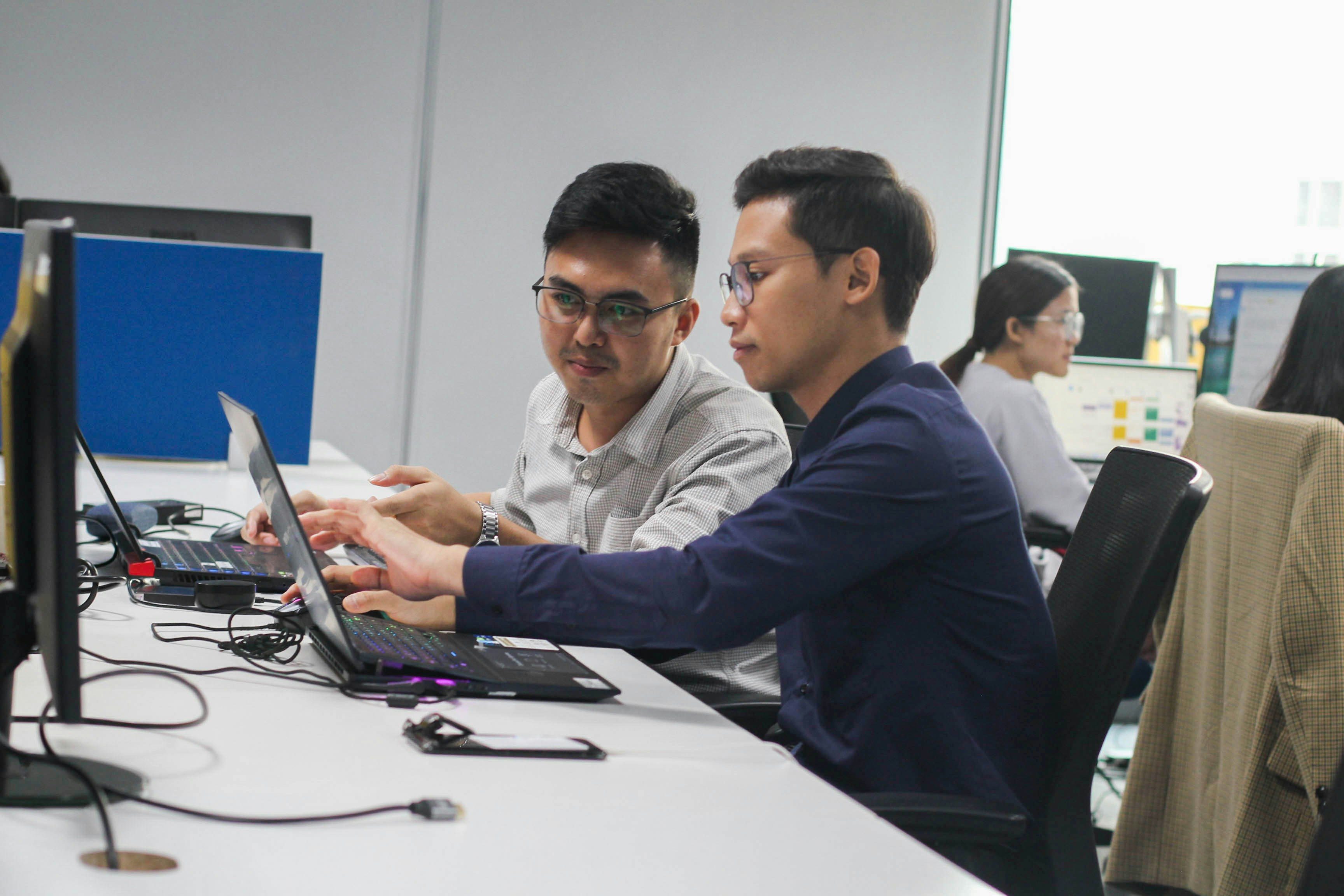 a modern office team working with laptops and dashboards.